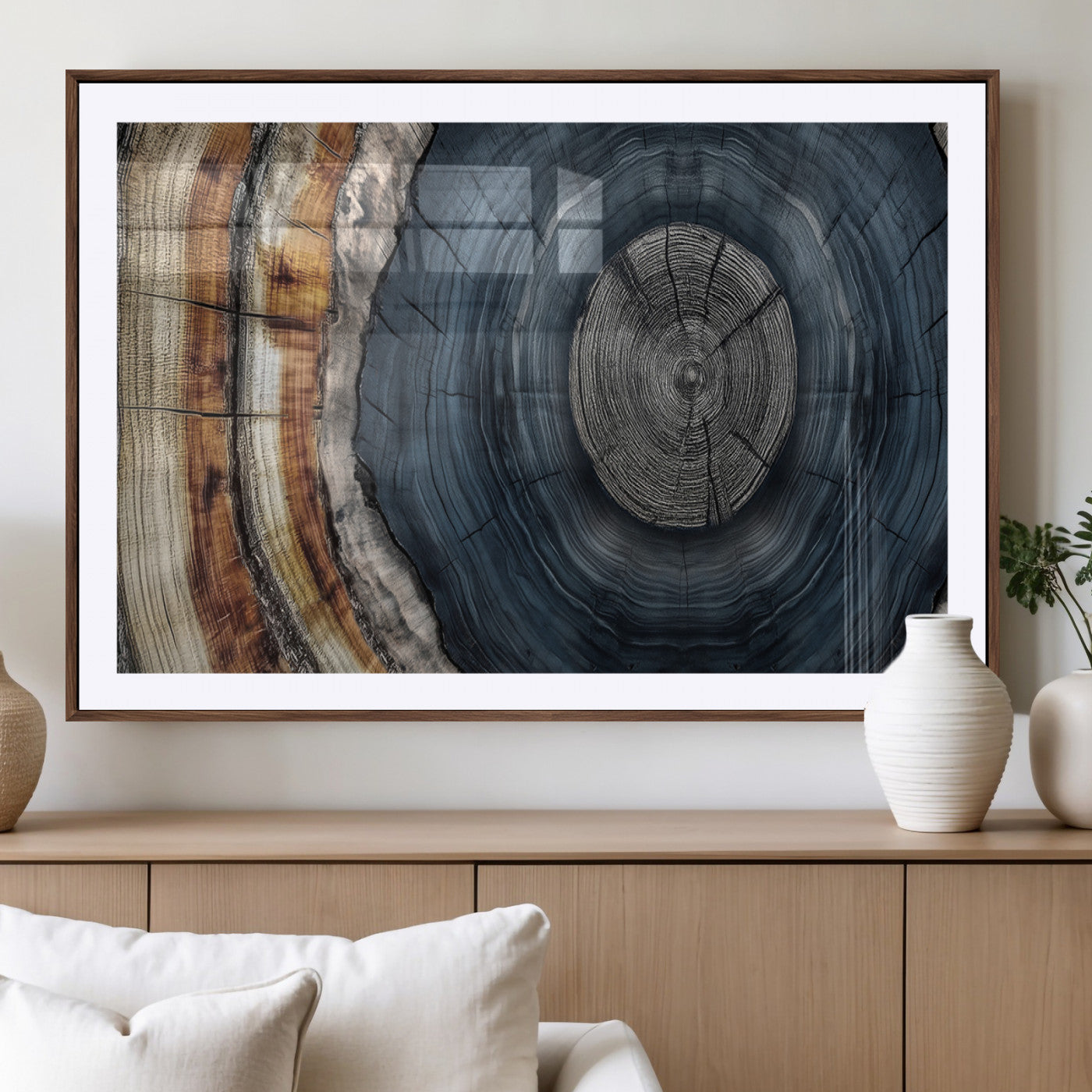 A stunning close-up of a tree trunk showing the intricate, circular growth rings, showcasing the natural textures and rich contrasts in deep blues, browns, and silvers.