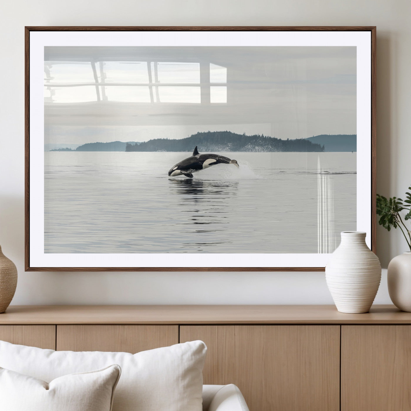 An orca jumping out of calm ocean waters with a misty island in the background, creating a serene and minimalist marine wildlife scene.