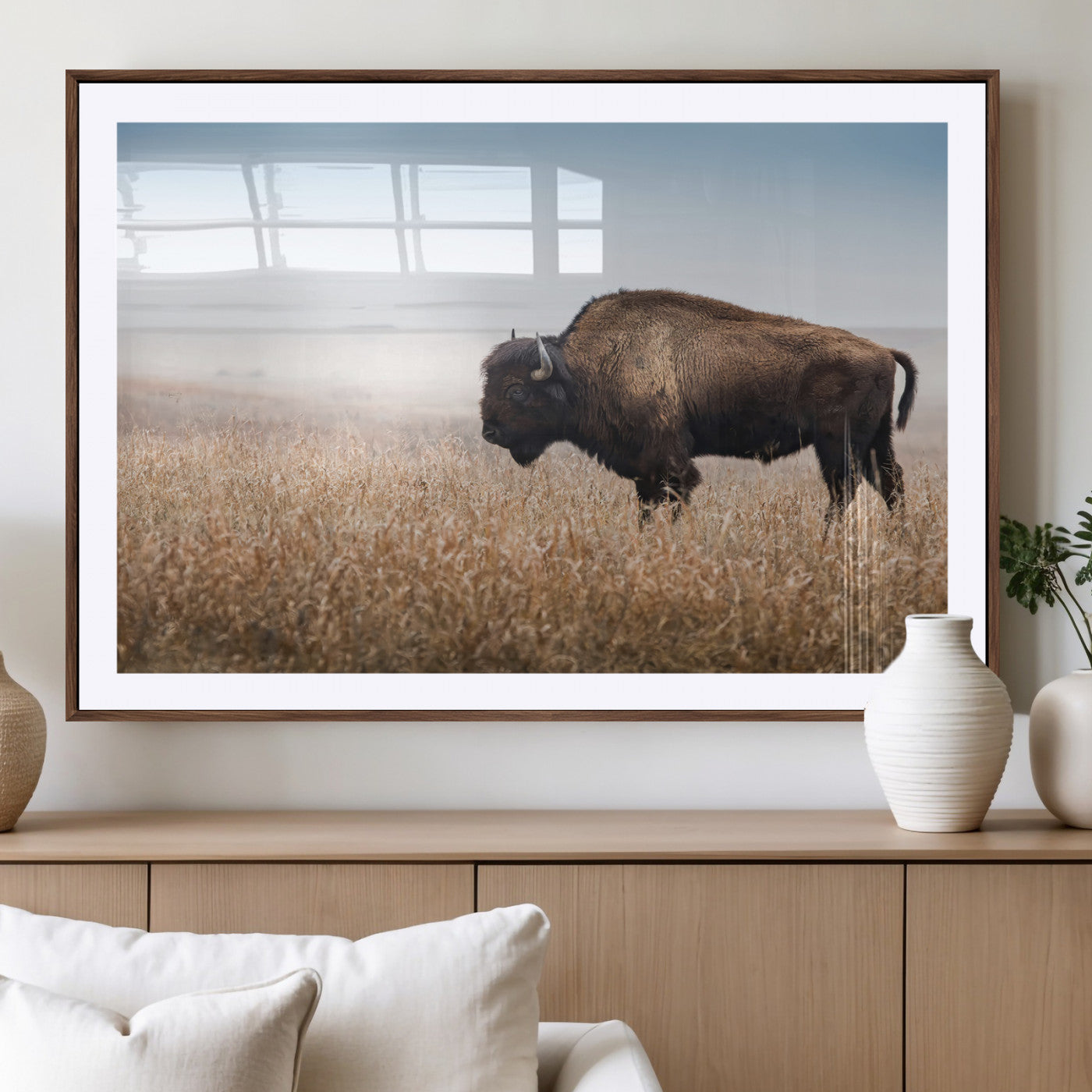 A majestic bison standing in an open prairie field, its strong form blending into the golden grass under a vast blue sky, evoking the wild spirit of the American plains.
