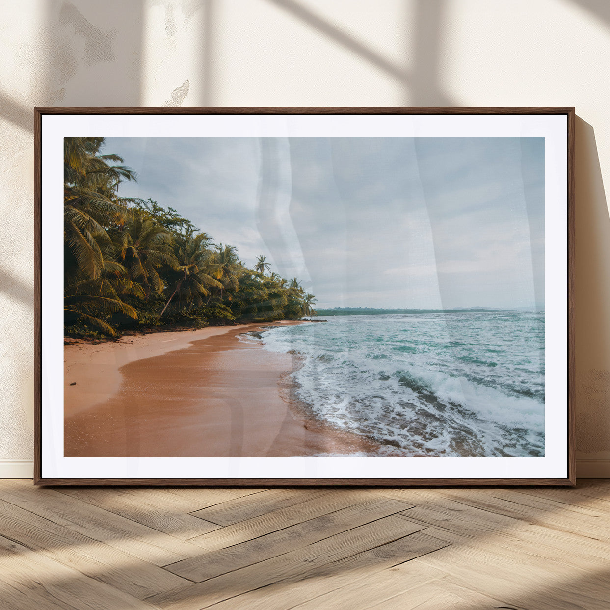 Framed canvas of a tropical beach with palm trees and soft waves, ideal for coastal escape or serene nature-inspired home decor.
