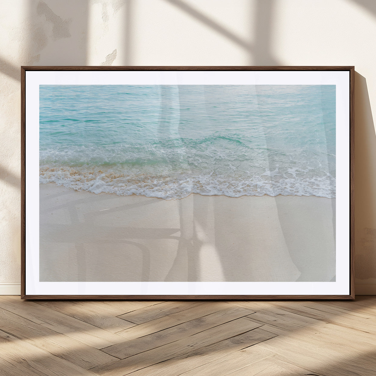 Soft shoreline with gentle aqua waves on smooth sand, ideal for minimalist coastal or pastel ocean-inspired home wall decor.