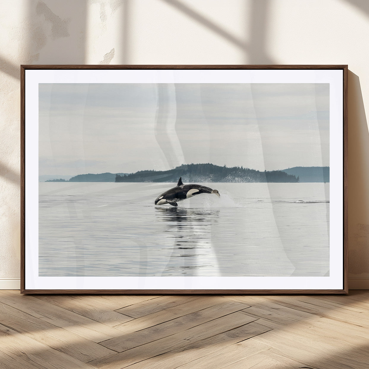 An orca jumping out of calm ocean waters with a misty island in the background, creating a serene and minimalist marine wildlife scene.