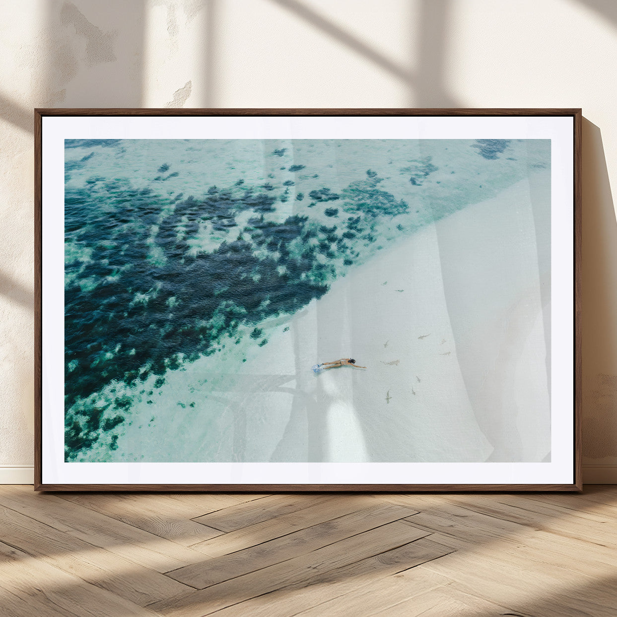 Canvas featuring an aerial view of a swimmer in shallow turquoise waters with coral patterns, ideal for tropical coastal home decor.