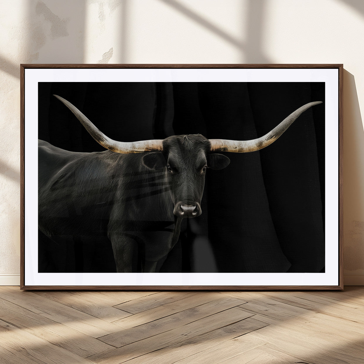 Close-up of a black Texas longhorn with large curved horns on black background, ideal for rustic farmhouse or modern western interiors.