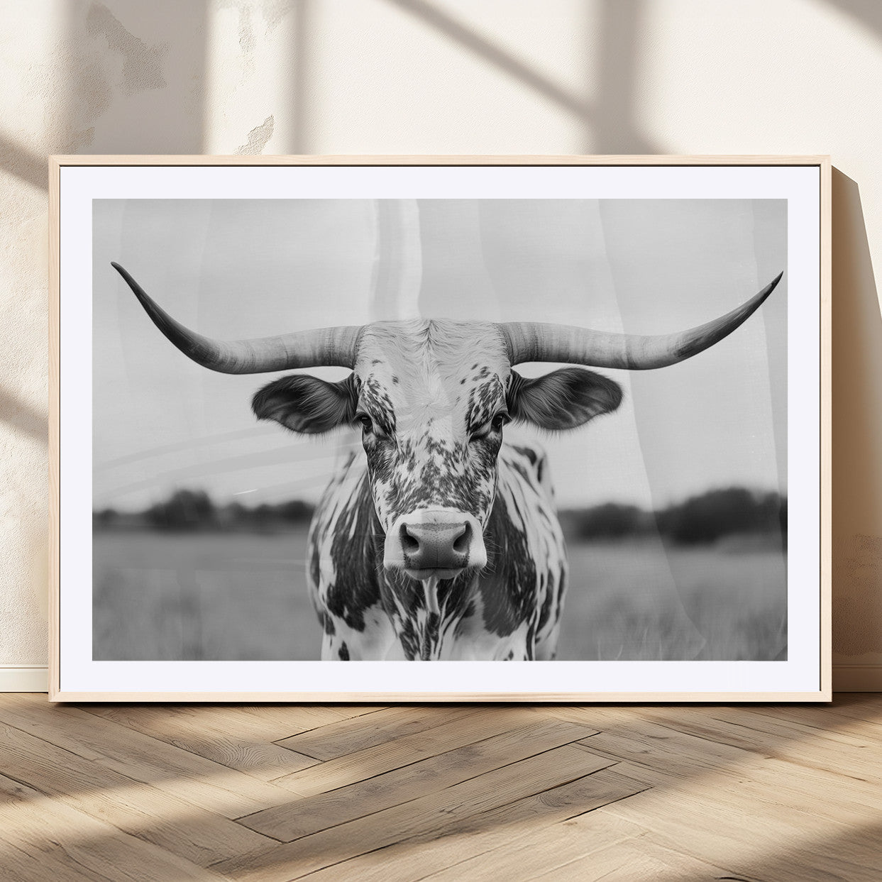 Capture the strength and elegance of nature with this striking black and white portrait of a longhorn cow. Its powerful presence makes a bold statement in any room.