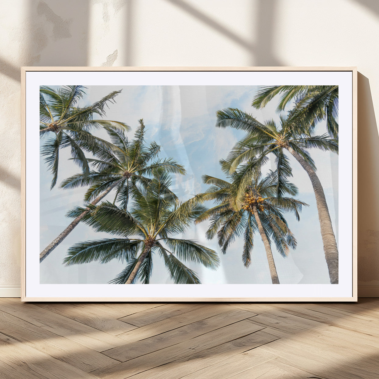 Framed canvas of tall palm trees reaching into a tropical sky, ideal for beach home or relaxed island-inspired wall decor.