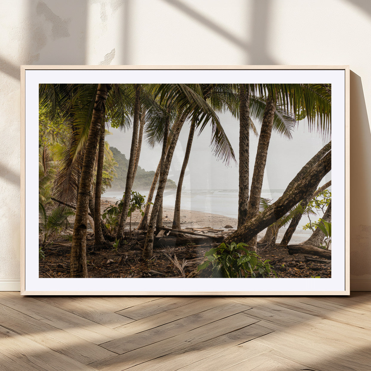 Dense tropical palm trees framing a sandy beach and ocean shore, ideal for jungle or coastal themed interior wall decor.