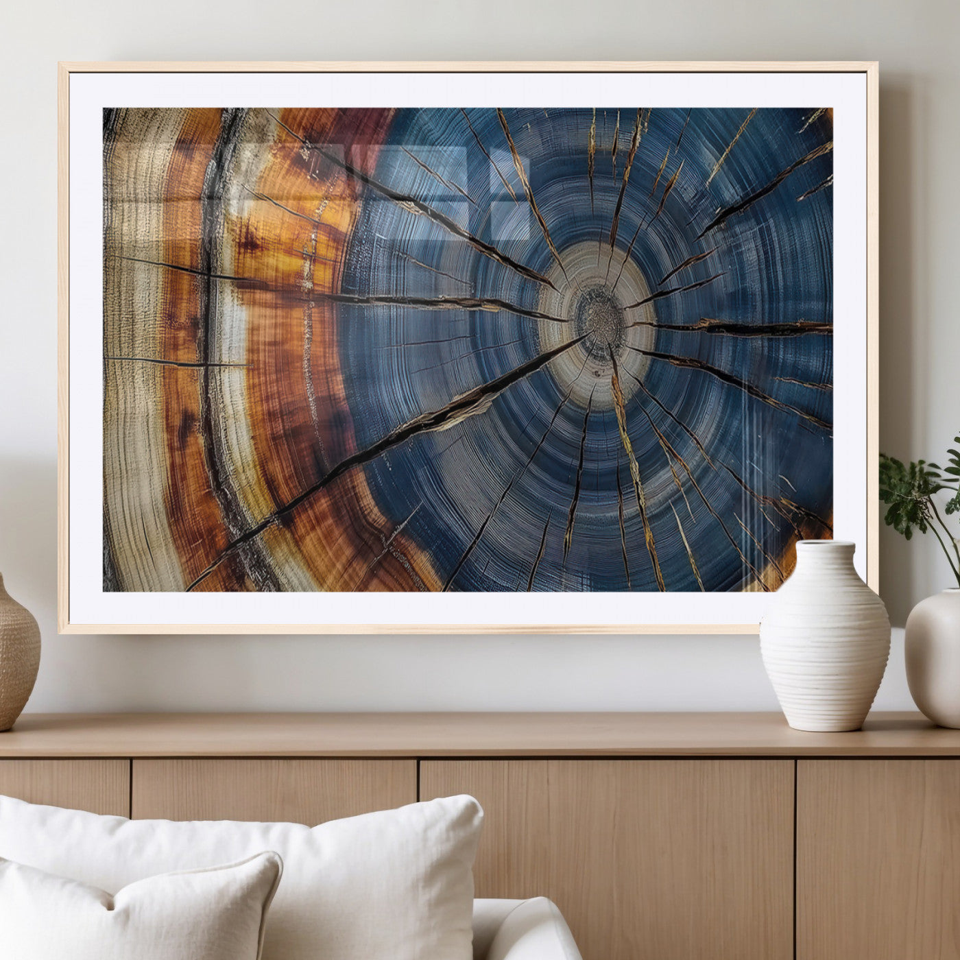A stunning close-up view of a tree trunk, showcasing the intricate growth rings in a vibrant mix of warm browns, cool blues, and hints of natural texture.