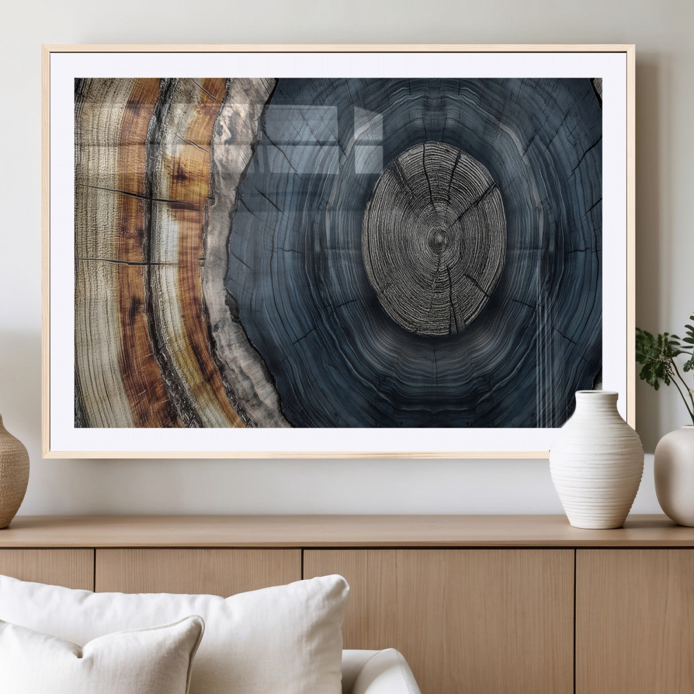 A stunning close-up of a tree trunk showing the intricate, circular growth rings, showcasing the natural textures and rich contrasts in deep blues, browns, and silvers.