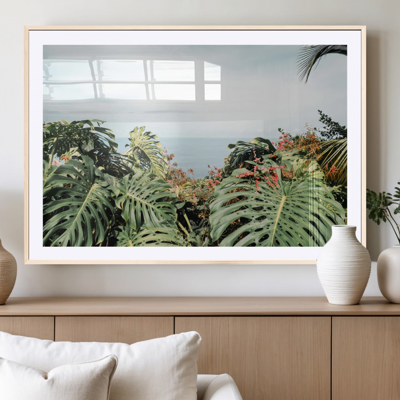 Monstera leaves and tropical flowers framing a calm ocean view, ideal for tropical coastal or exotic jungle-style interior wall decor.