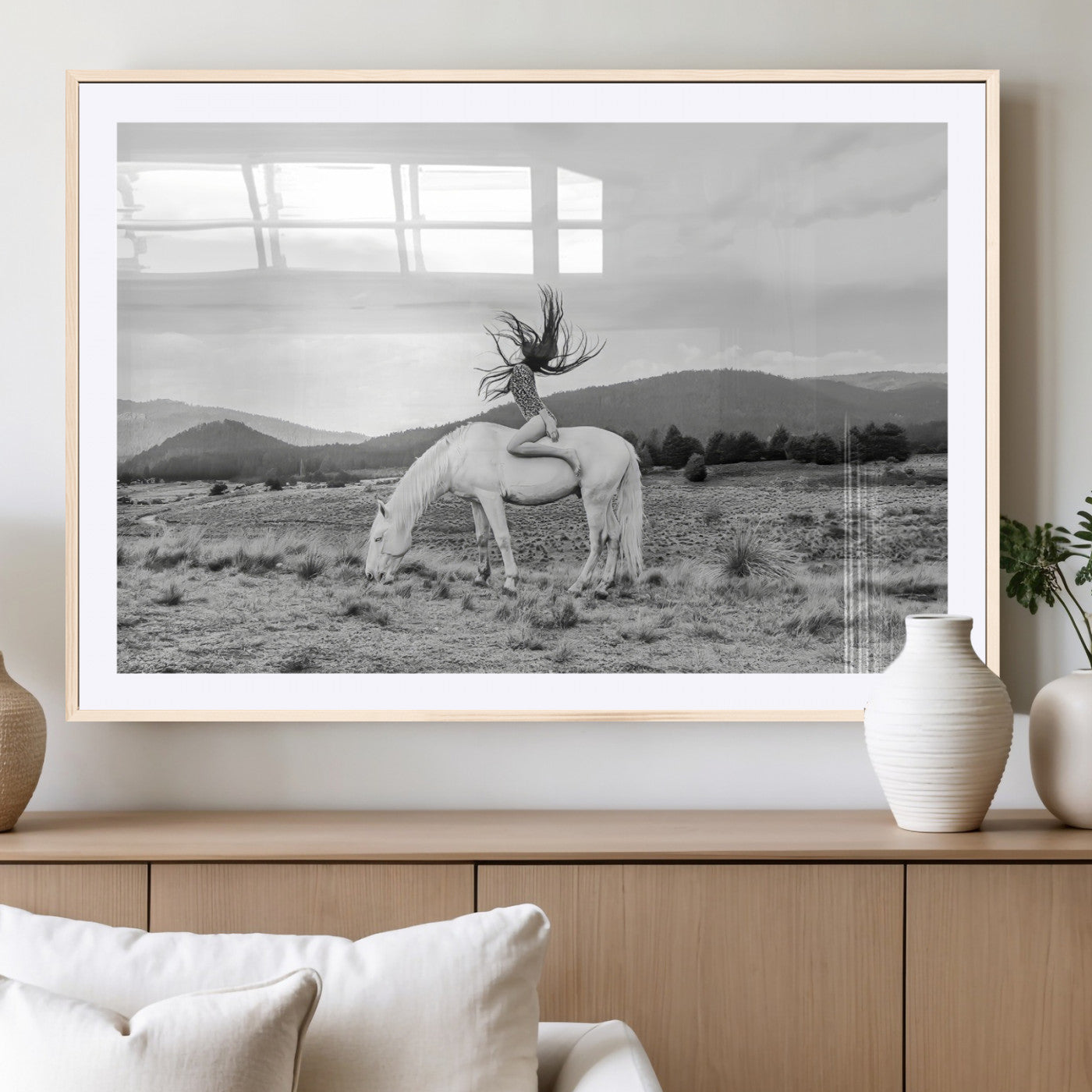 Black and white photo of a woman on a white horse in moody tones, ideal for Western Boho or modern rustic-style home decor.