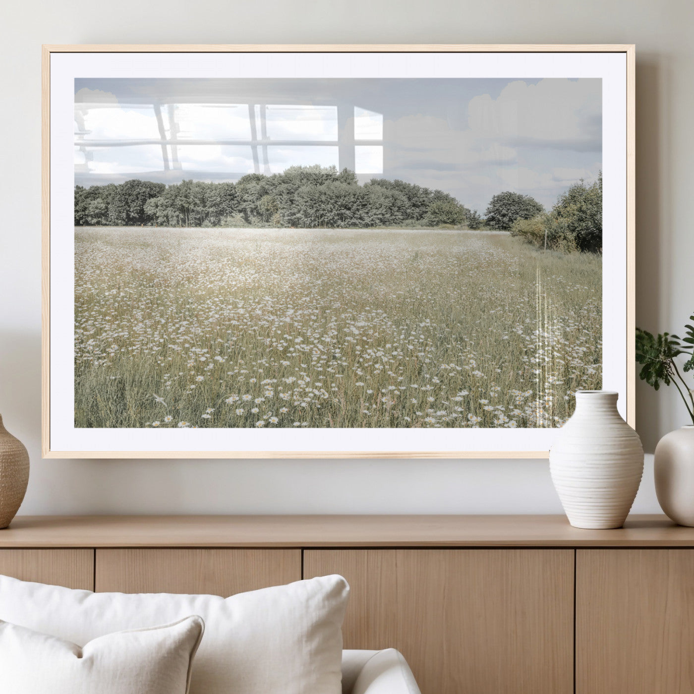 Soft-toned image of a wild daisy field under a cloudy sky, ideal for neutral or Scandinavian-inspired home decor.