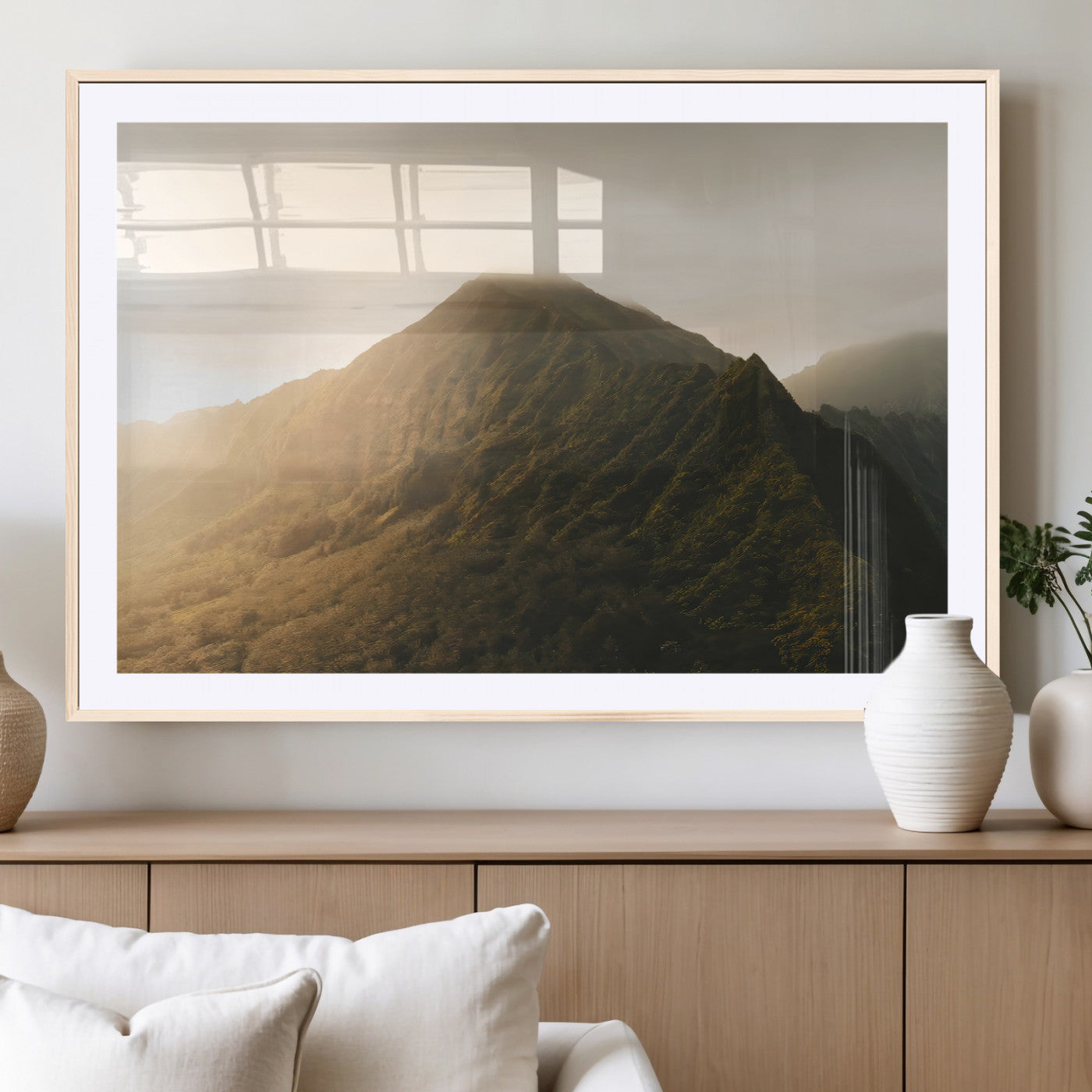 Sunlit mountain peak with mist rolling over its rugged slopes, bathed in golden light, creating a warm and tranquil nature-inspired scene.