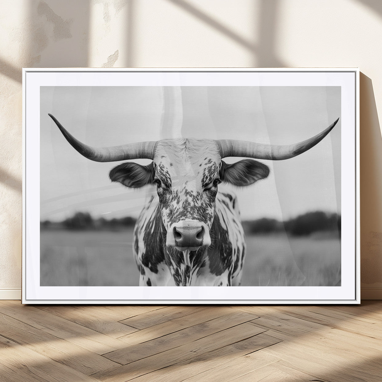 Capture the strength and elegance of nature with this striking black and white portrait of a longhorn cow. Its powerful presence makes a bold statement in any room.
