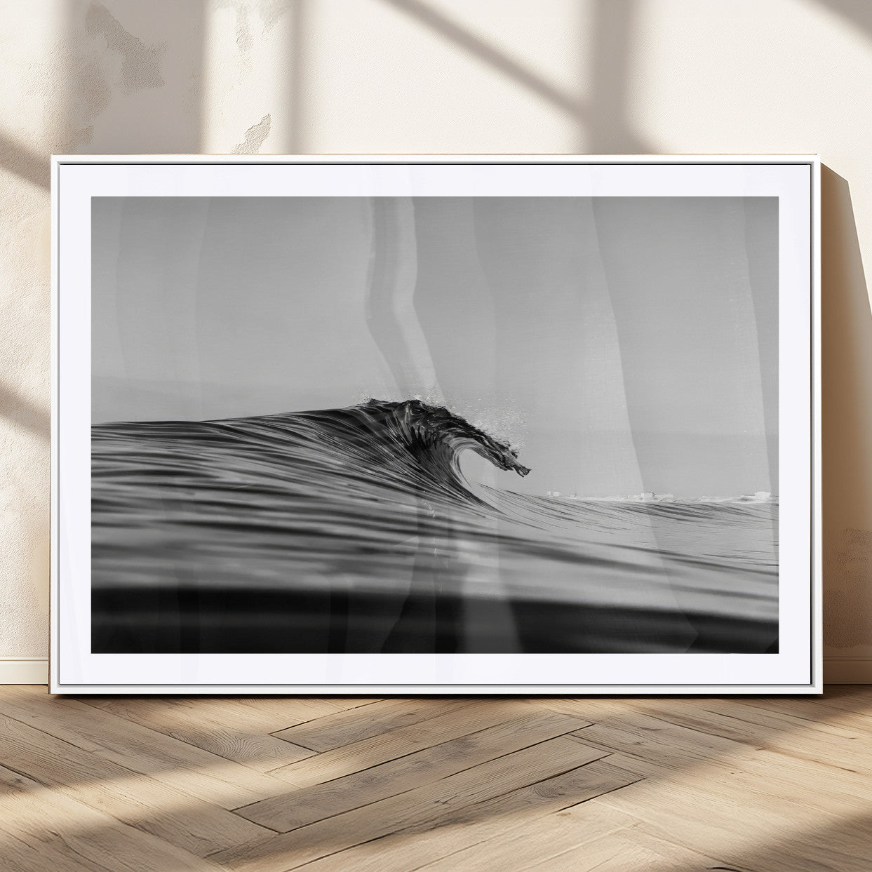 Striking black and white photo of a curling wave, ideal for modern coastal or minimalist wall decor settings.