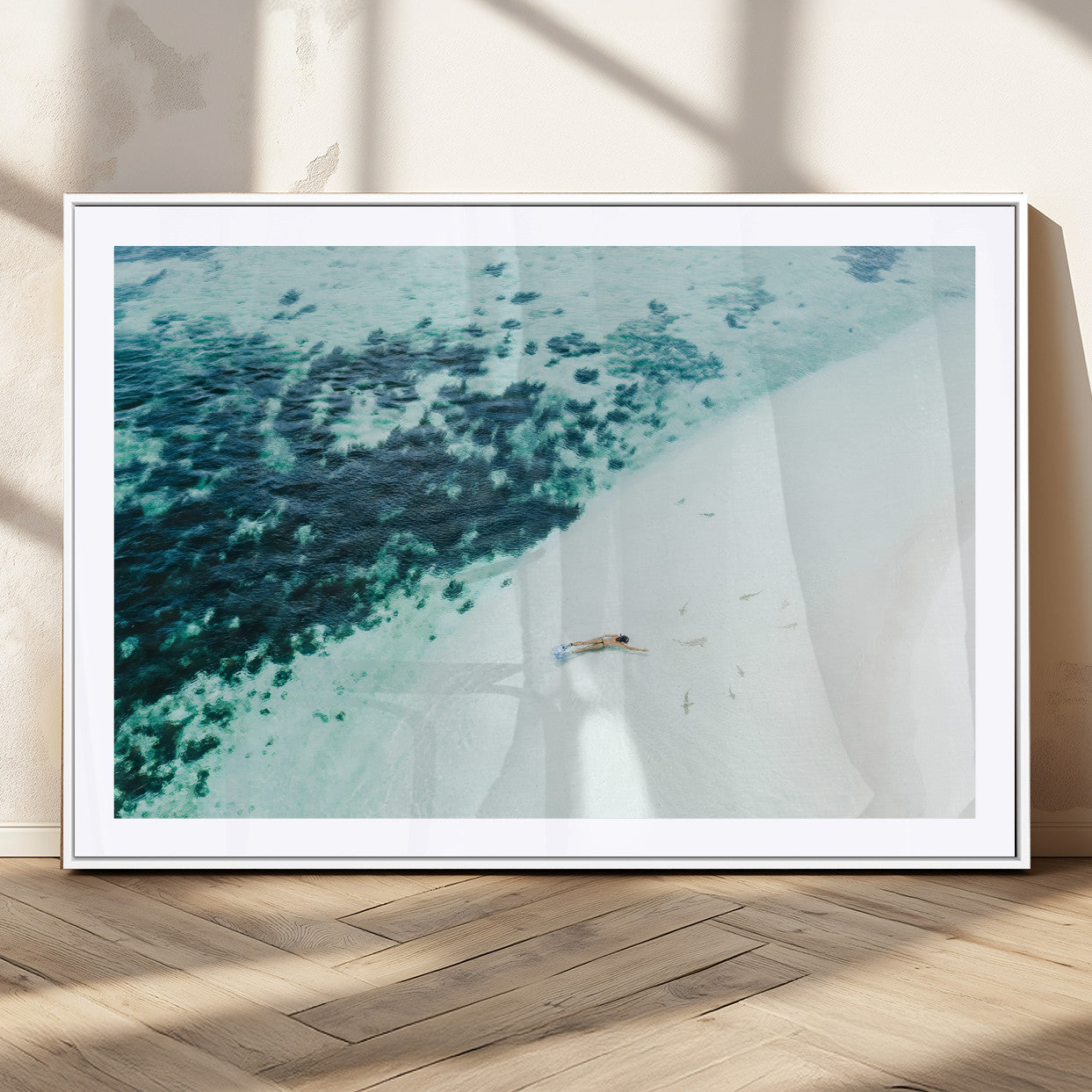 Canvas featuring an aerial view of a swimmer in shallow turquoise waters with coral patterns, ideal for tropical coastal home decor.