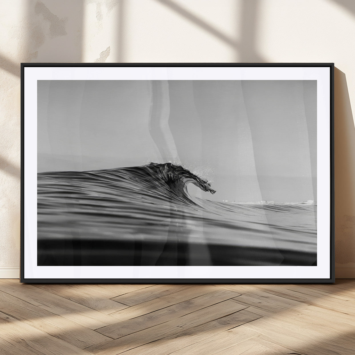 Striking black and white photo of a curling wave, ideal for modern coastal or minimalist wall decor settings.