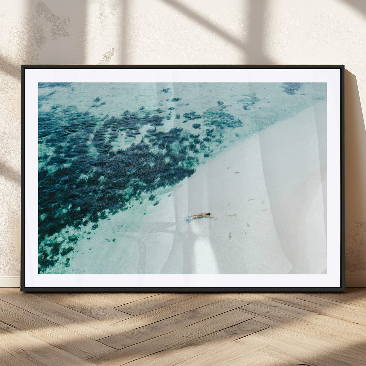 Canvas featuring an aerial view of a swimmer in shallow turquoise waters with coral patterns, ideal for tropical coastal home decor.