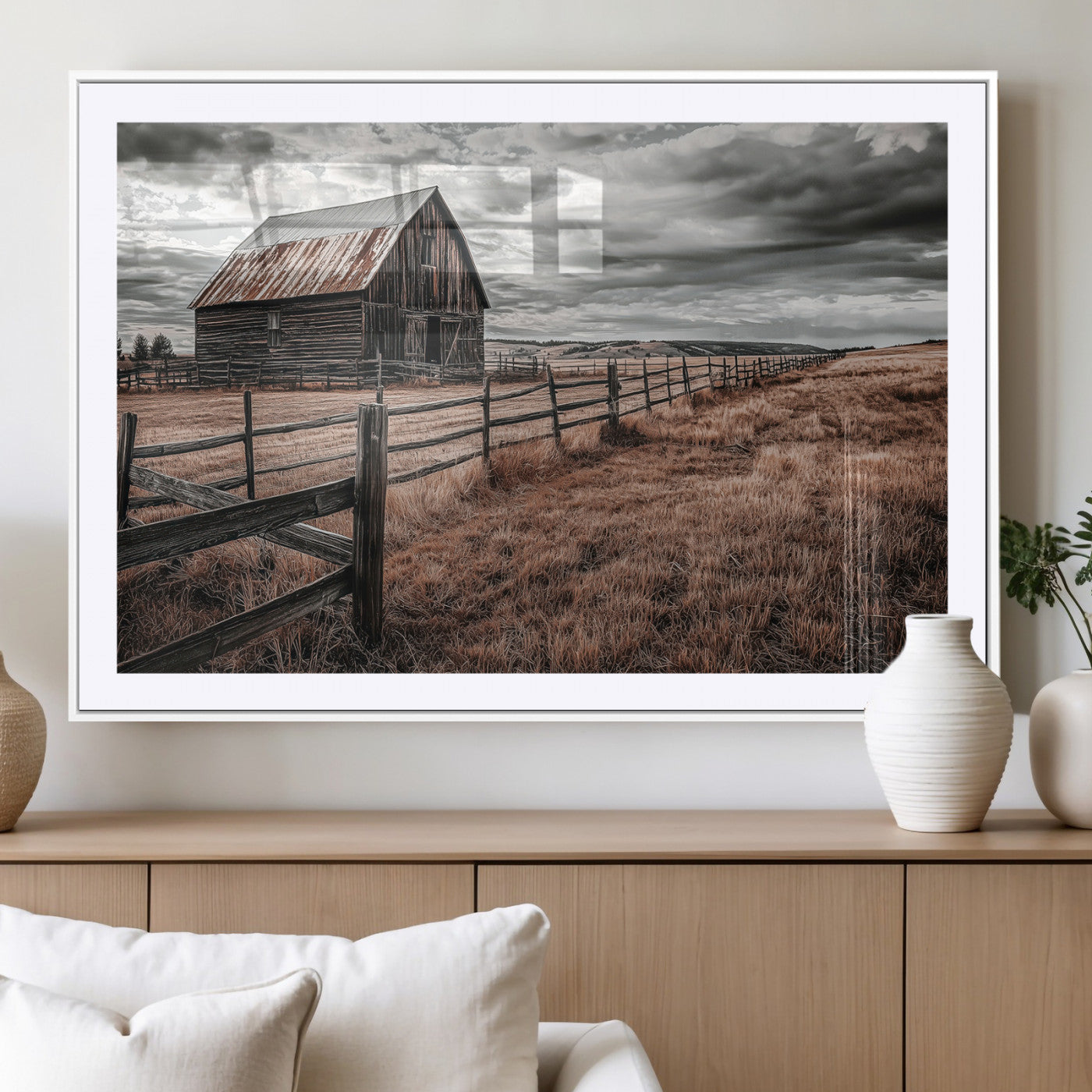 Framed canvas of a rustic barn under a moody sky with weathered fence and dark fields, ideal for farmhouse or rural-style wall decor.