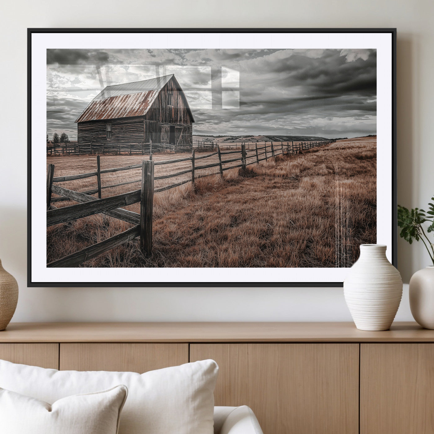 Framed canvas of a rustic barn under a moody sky with weathered fence and dark fields, ideal for farmhouse or rural-style wall decor.