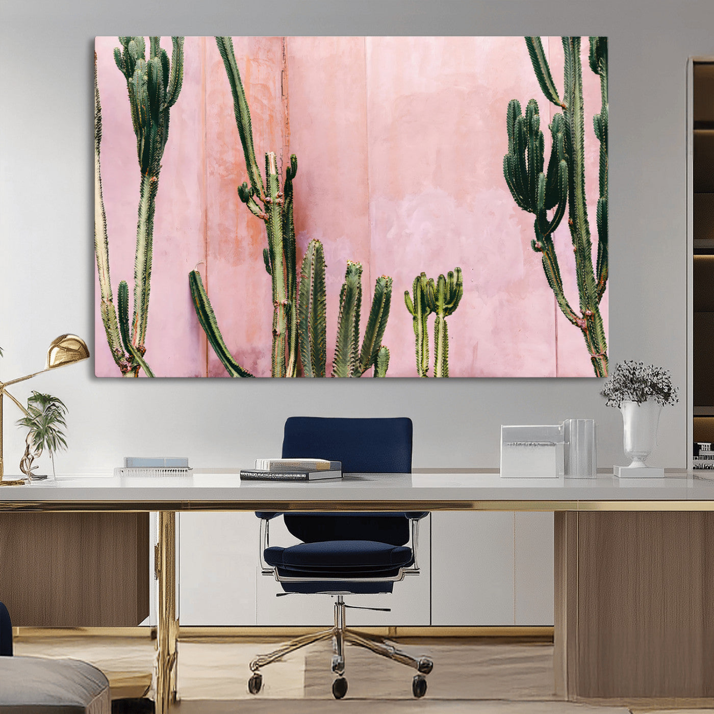 Framed canvas of tall green cacti against a soft pink wall, ideal for modern desert or colorful southwest-inspired home decor.
