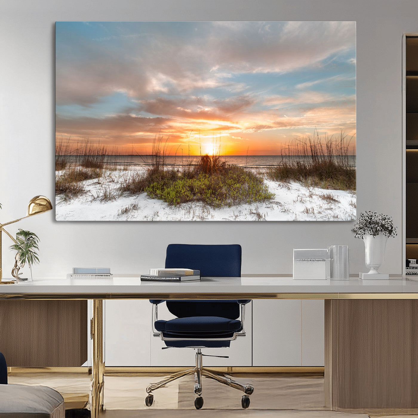 A tranquil beach scene featuring golden sunset hues over the water, with grasses in the foreground and a peaceful, serene atmosphere.