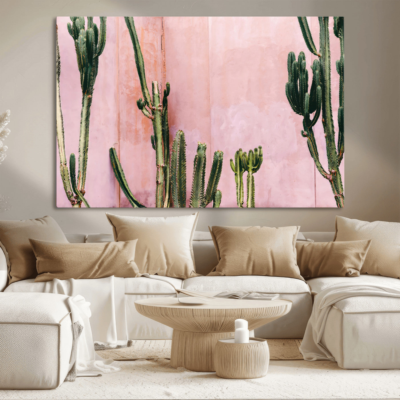 Framed canvas of tall green cacti against a soft pink wall, ideal for modern desert or colorful southwest-inspired home decor.