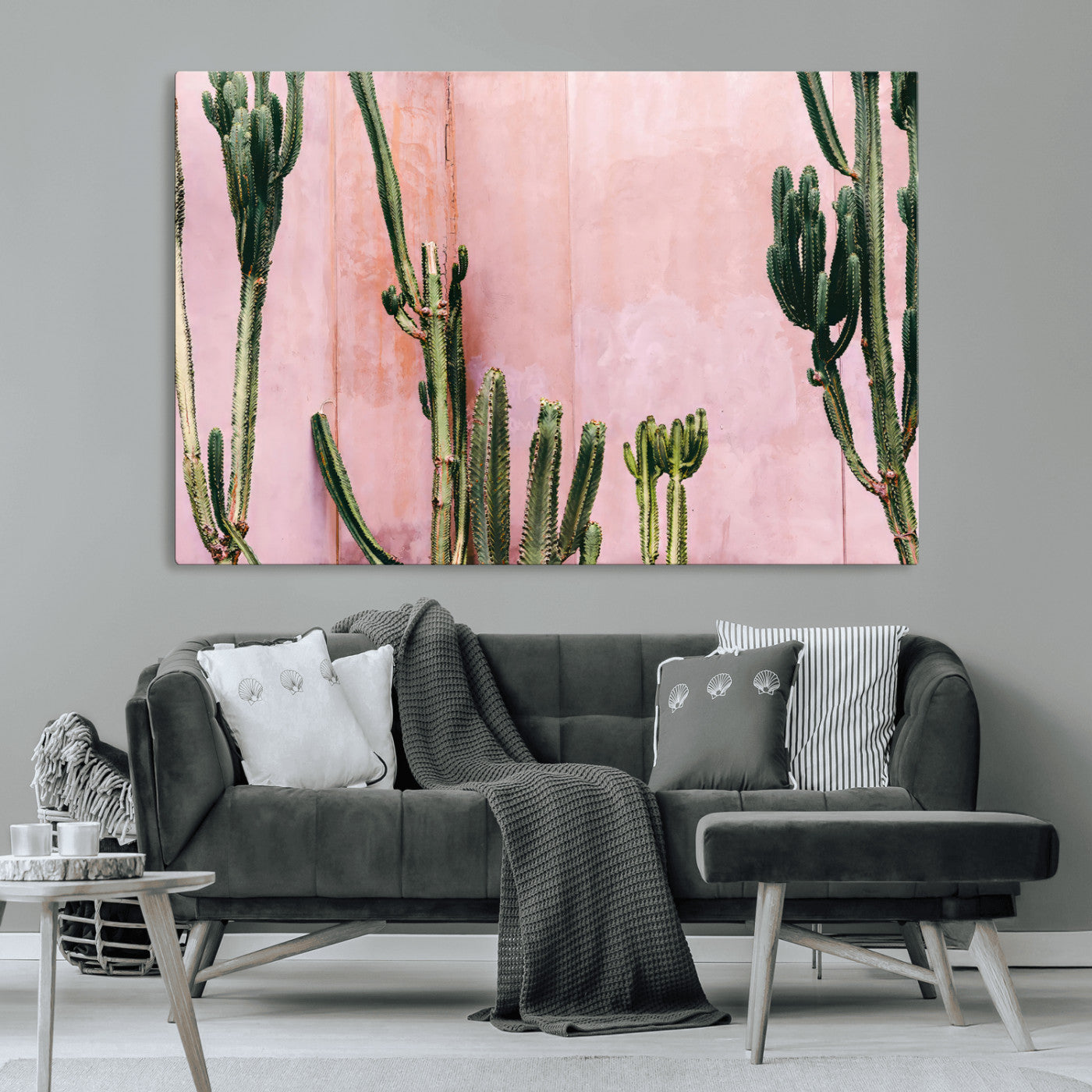 Framed canvas of tall green cacti against a soft pink wall, ideal for modern desert or colorful southwest-inspired home decor.