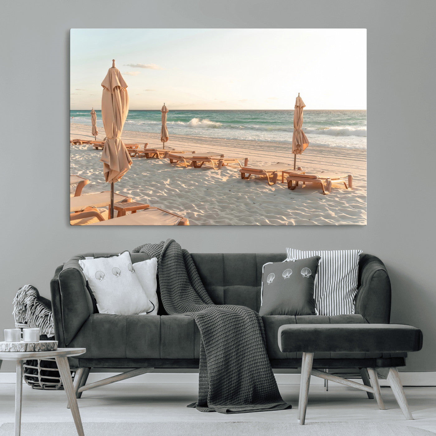 Minimalist photo of empty beach loungers and umbrellas on soft sand, ideal for calm seaside or pastel coastal-style home decor.