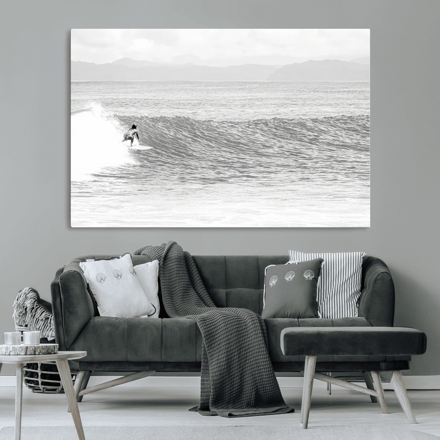 Monochrome photo of a surfer riding a wave with distant mountains, ideal for coastal motion or black and white surf-themed wall decor.