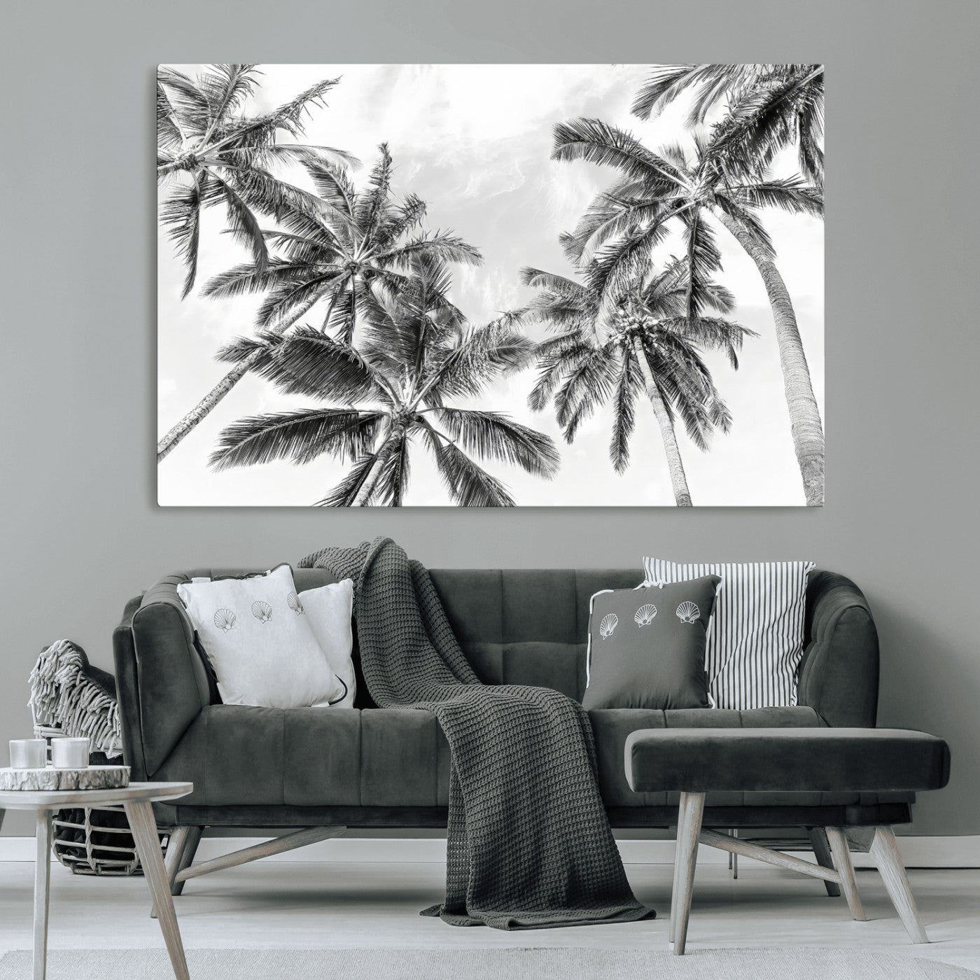 Black and white tropical palm trees viewed from below, swaying gently against a bright sky, creating a serene and elegant coastal atmosphere.