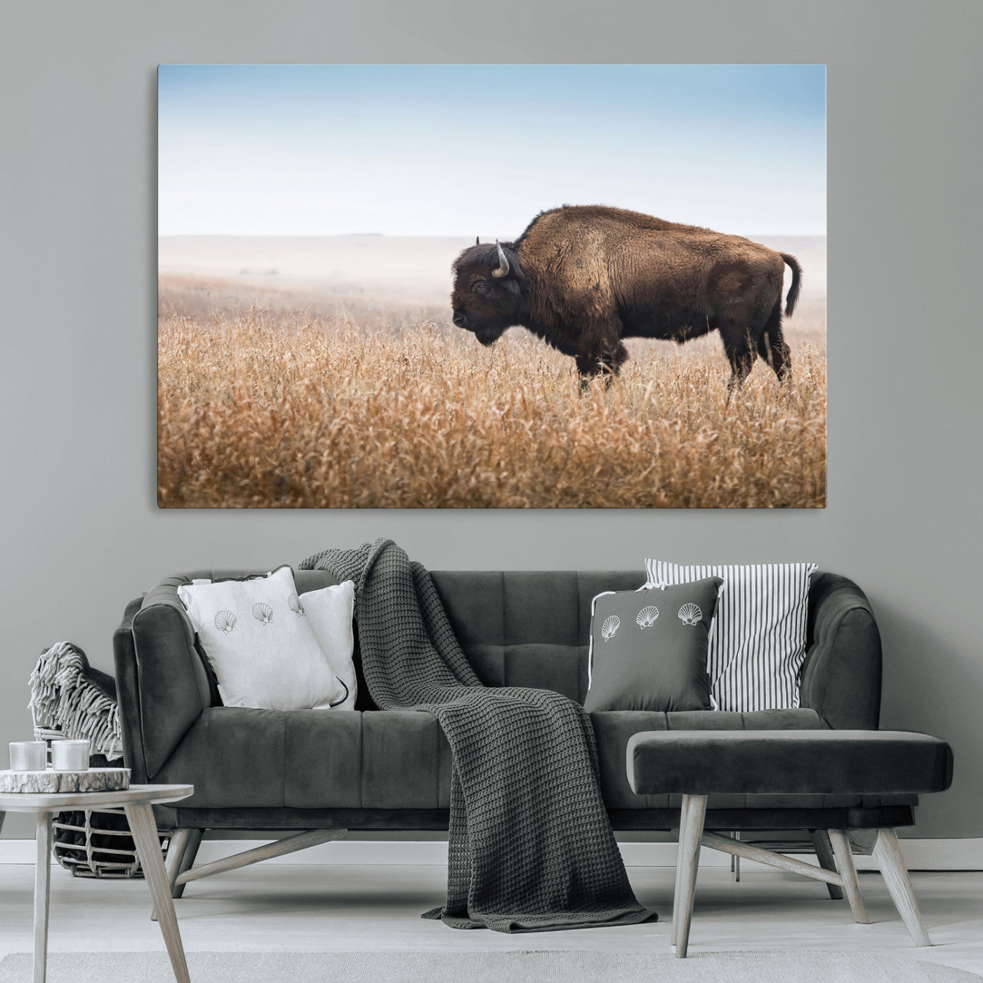 A majestic bison standing in an open prairie field, its strong form blending into the golden grass under a vast blue sky, evoking the wild spirit of the American plains.