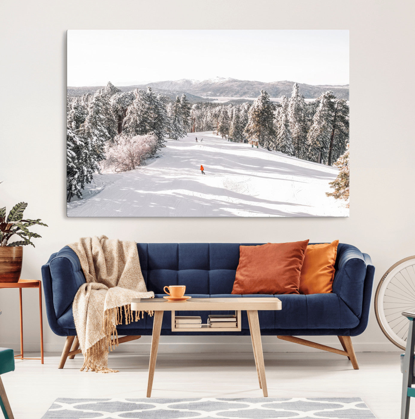 Bright ski trail lined with snow-covered pines and a skier in orange, perfect for alpine adventure or winter sports-inspired decor.