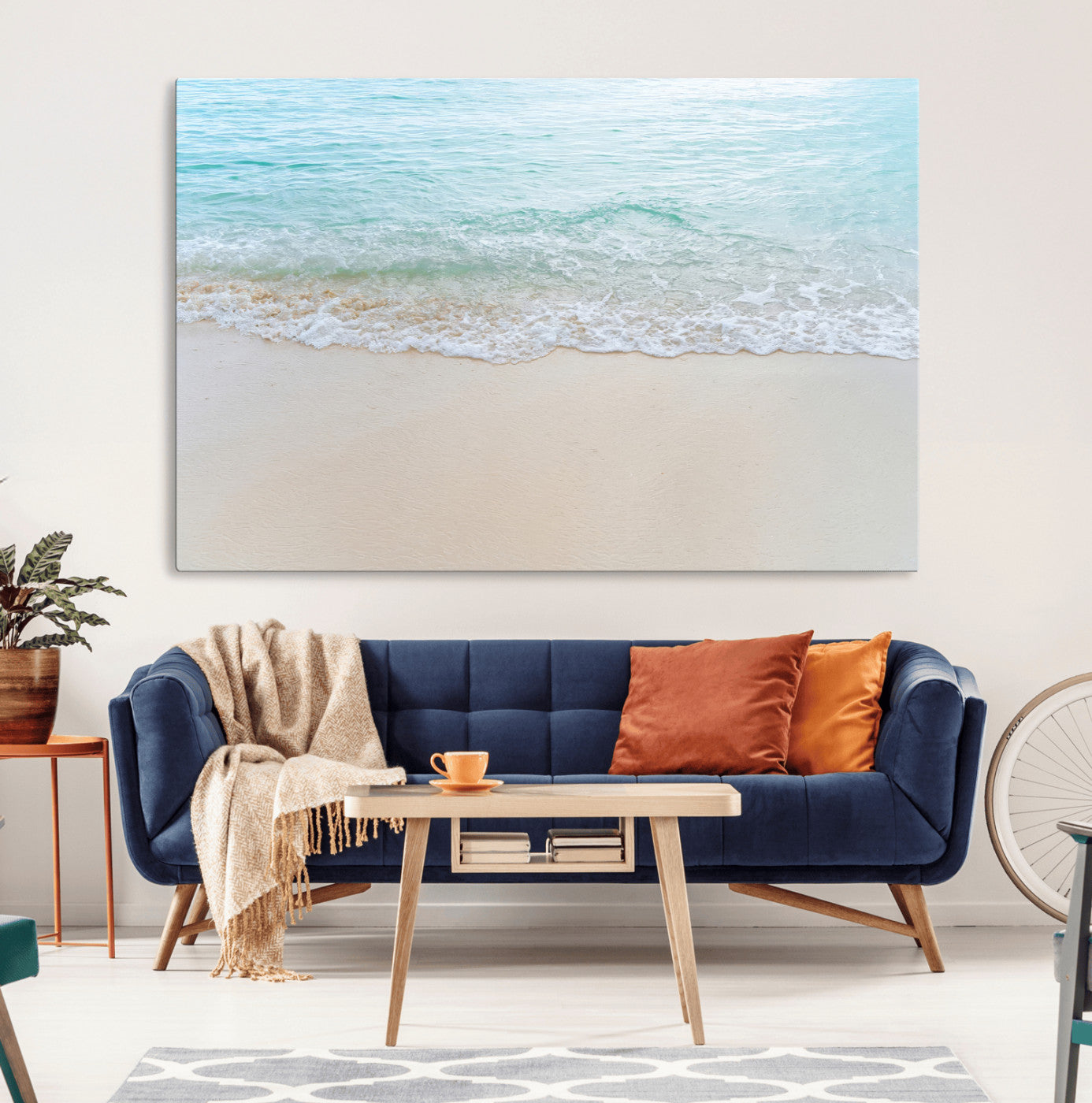 Soft shoreline with gentle aqua waves on smooth sand, ideal for minimalist coastal or pastel ocean-inspired home wall decor.