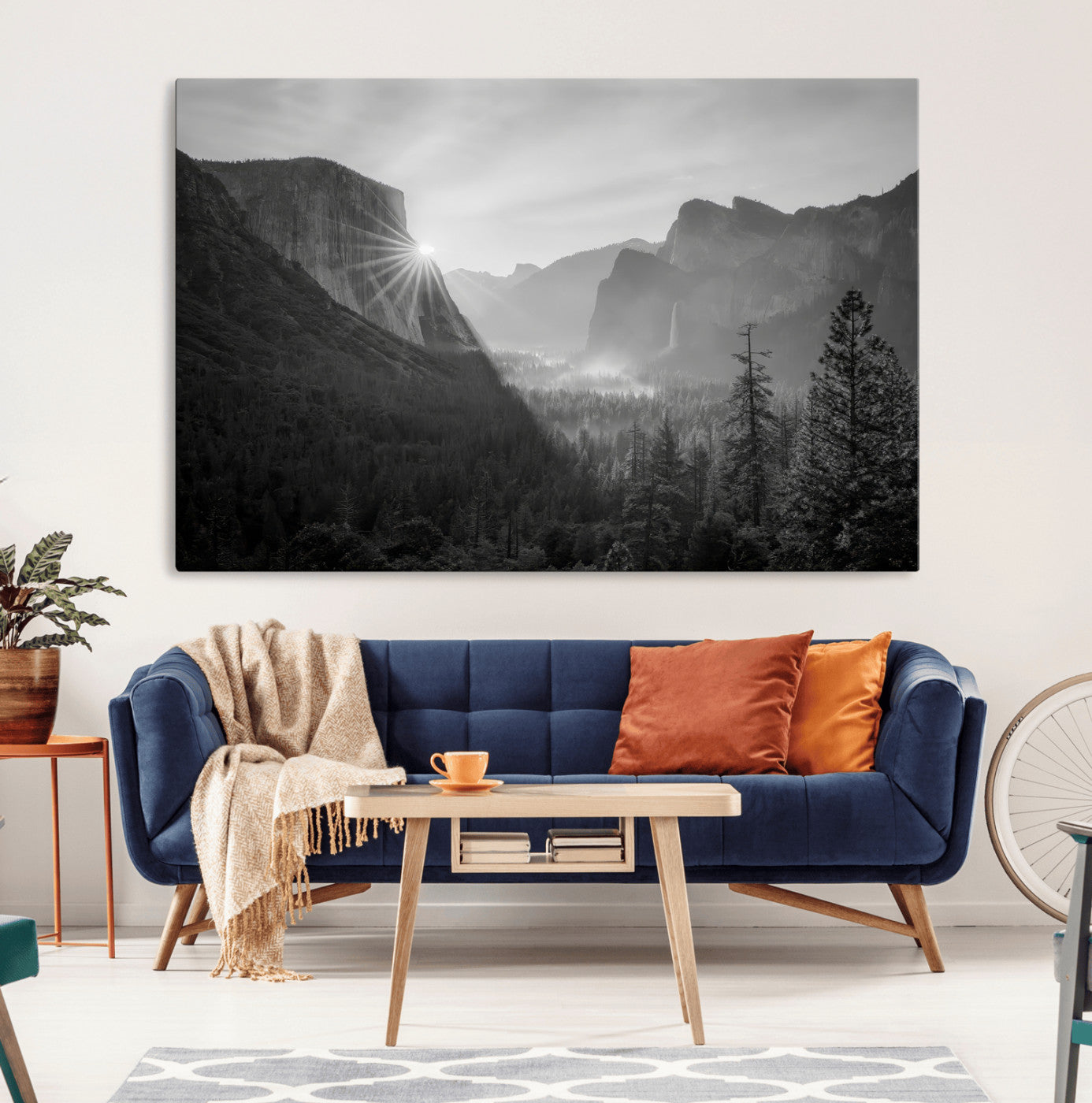 Black and white landscape of Yosemite with sun rays peeking over El Capitan, ideal for moody nature or modern rustic decor.