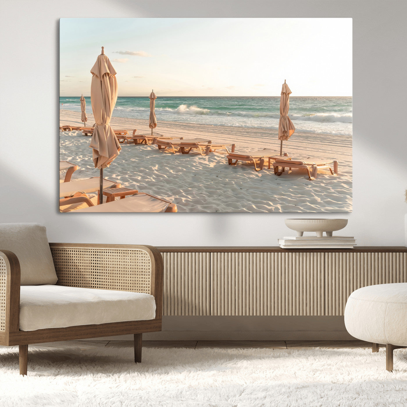 Minimalist photo of empty beach loungers and umbrellas on soft sand, ideal for calm seaside or pastel coastal-style home decor.