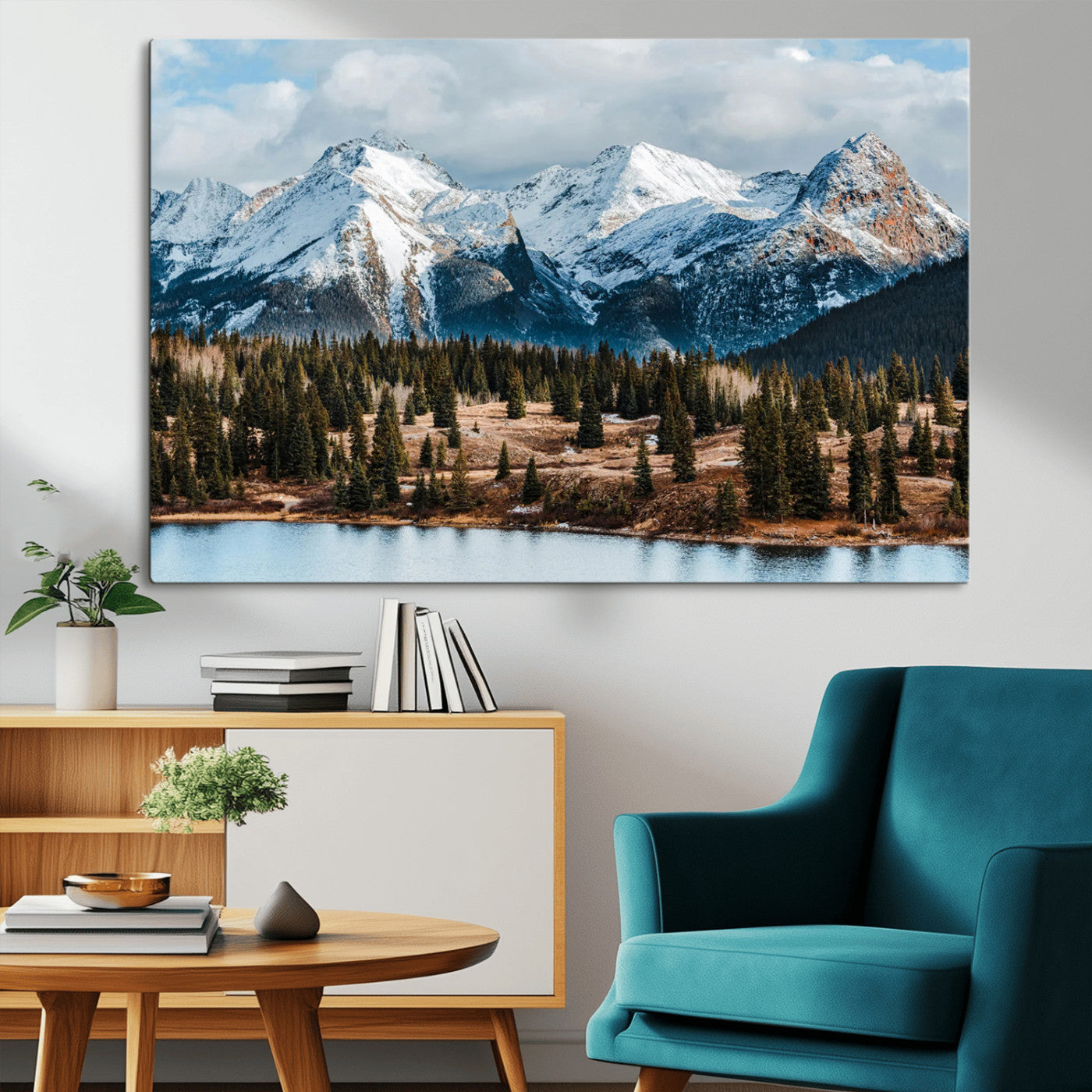 Framed canvas of snowy mountain peaks with pine forest and alpine lake, perfect for winter cabin or wilderness-inspired home decor.