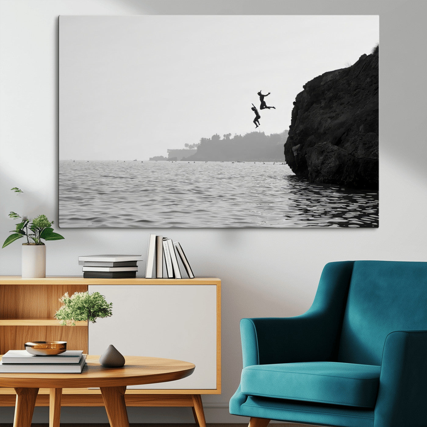 Black and white canvas of two figures cliff jumping into the sea, captured with moody tones, ideal for modern coastal or adventure-themed home decor. 2/2
