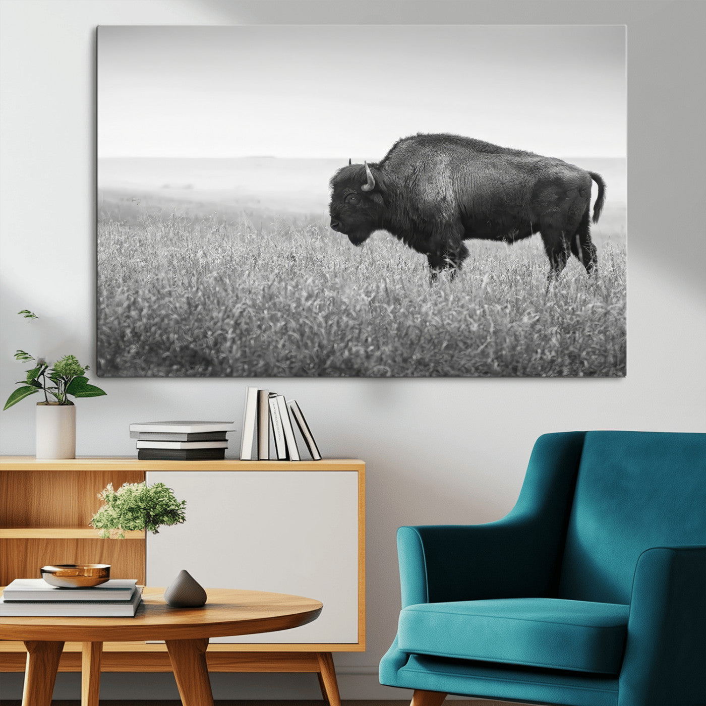A black and white photograph of a majestic bison standing in a vast grassy prairie, evoking a sense of wilderness and strength.