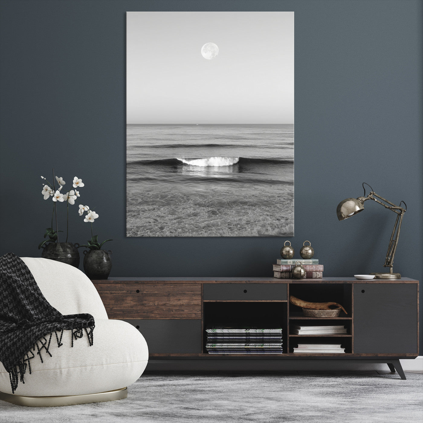 Black and white wall art of a calm ocean wave beneath a full moon, ideal for minimalist or monochrome coastal decor.