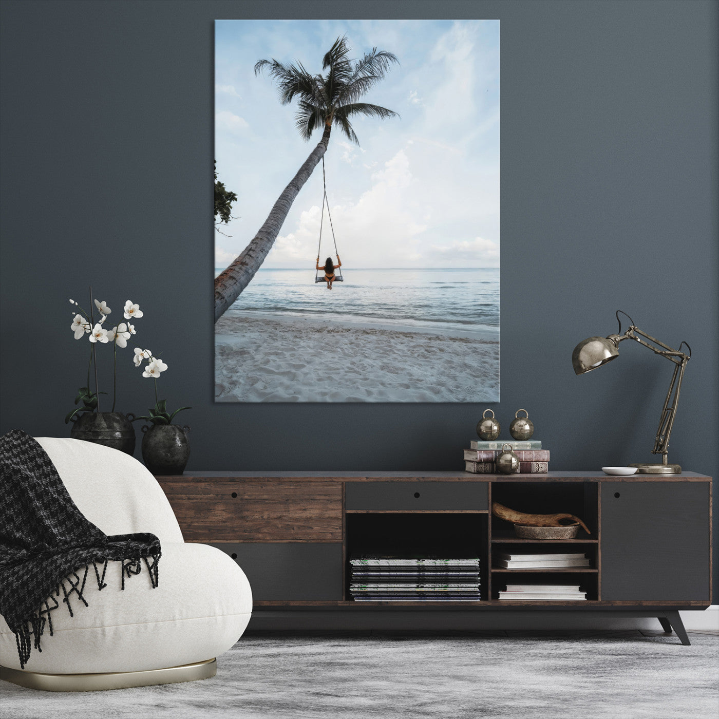 Wall art of a girl on a swing hanging from a palm tree over calm ocean waters, perfect for tropical or minimalist coastal decor.