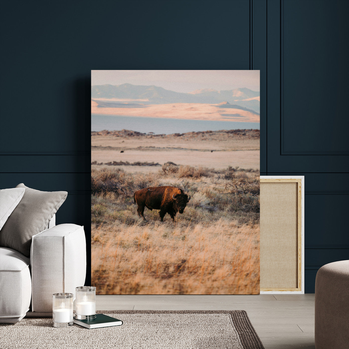 A solitary bison standing in golden prairie grass with distant mountains and soft sunset light, ideal for rustic, lodge, and western decor.