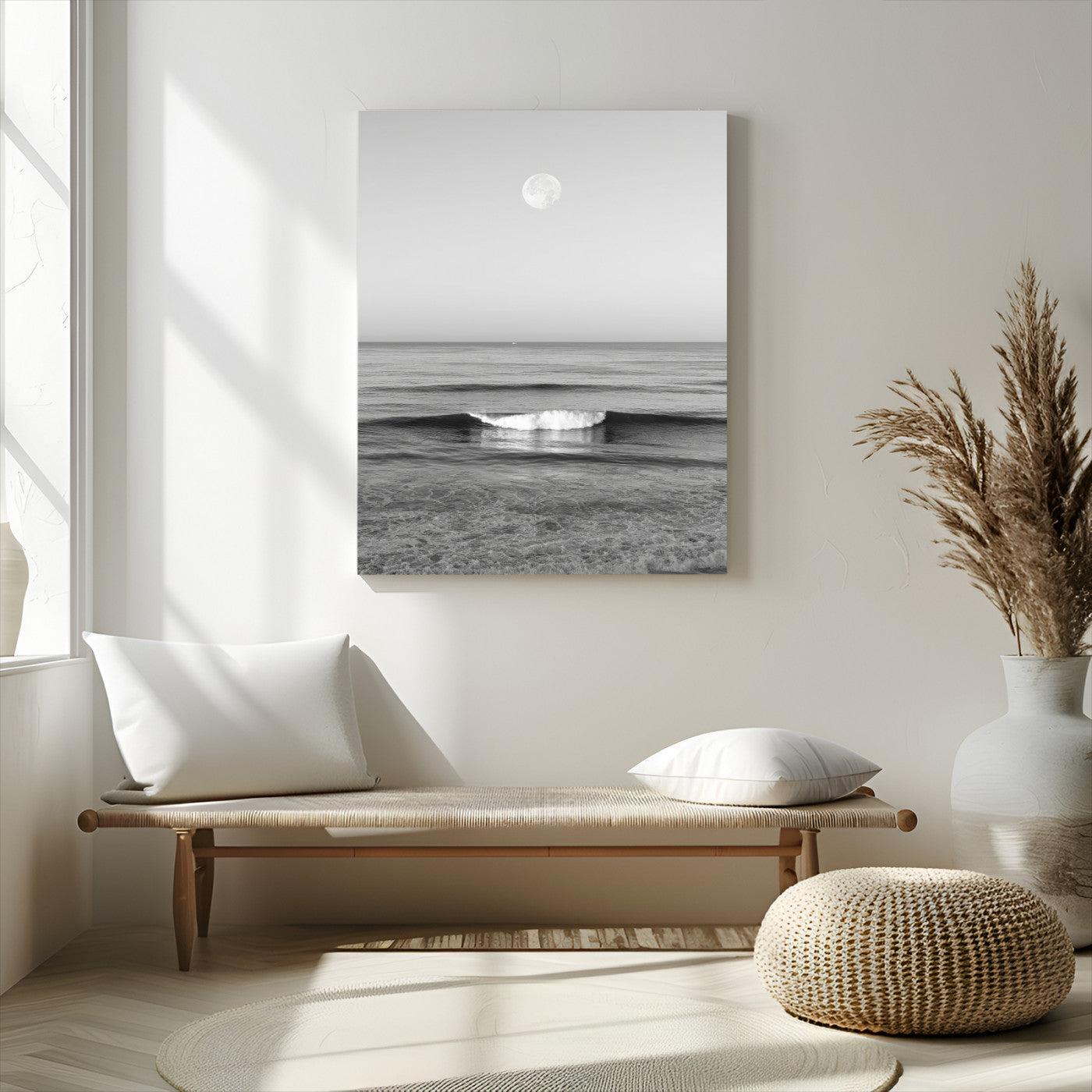 Black and white wall art of a calm ocean wave beneath a full moon, ideal for minimalist or monochrome coastal decor.