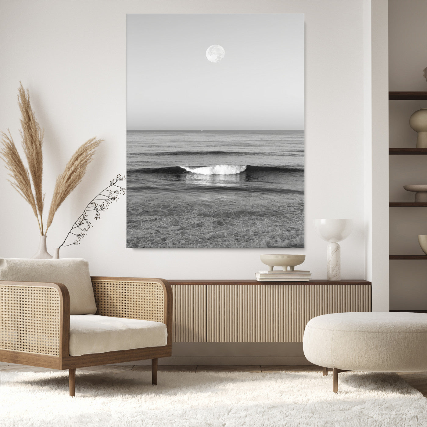 Black and white wall art of a calm ocean wave beneath a full moon, ideal for minimalist or monochrome coastal decor.