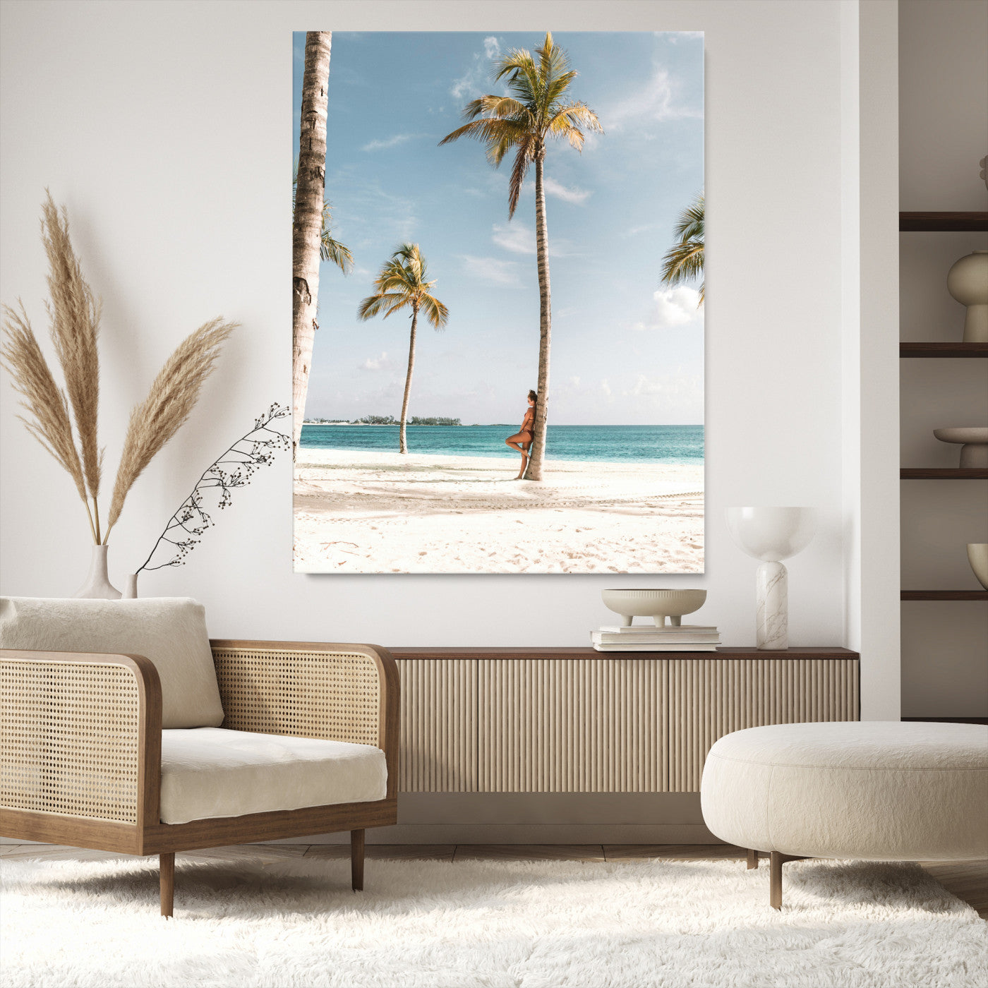 Person leaning on a palm tree at a tropical beach with white sand and turquoise water, perfect for coastal or beach-themed home decor.