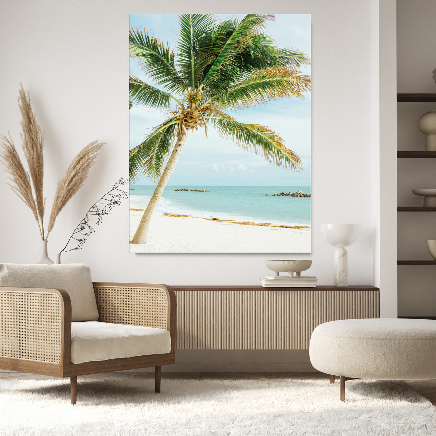 A tall palm tree leaning over a white sandy beach with turquoise ocean waves, creating a peaceful and tropical coastal scene.