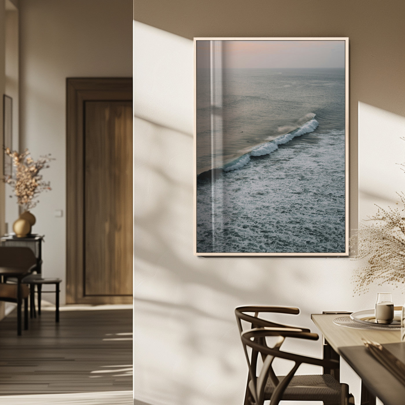 Aerial view of ocean waves rolling towards the shore under a soft sunset sky, creating a peaceful and minimalist coastal scene.