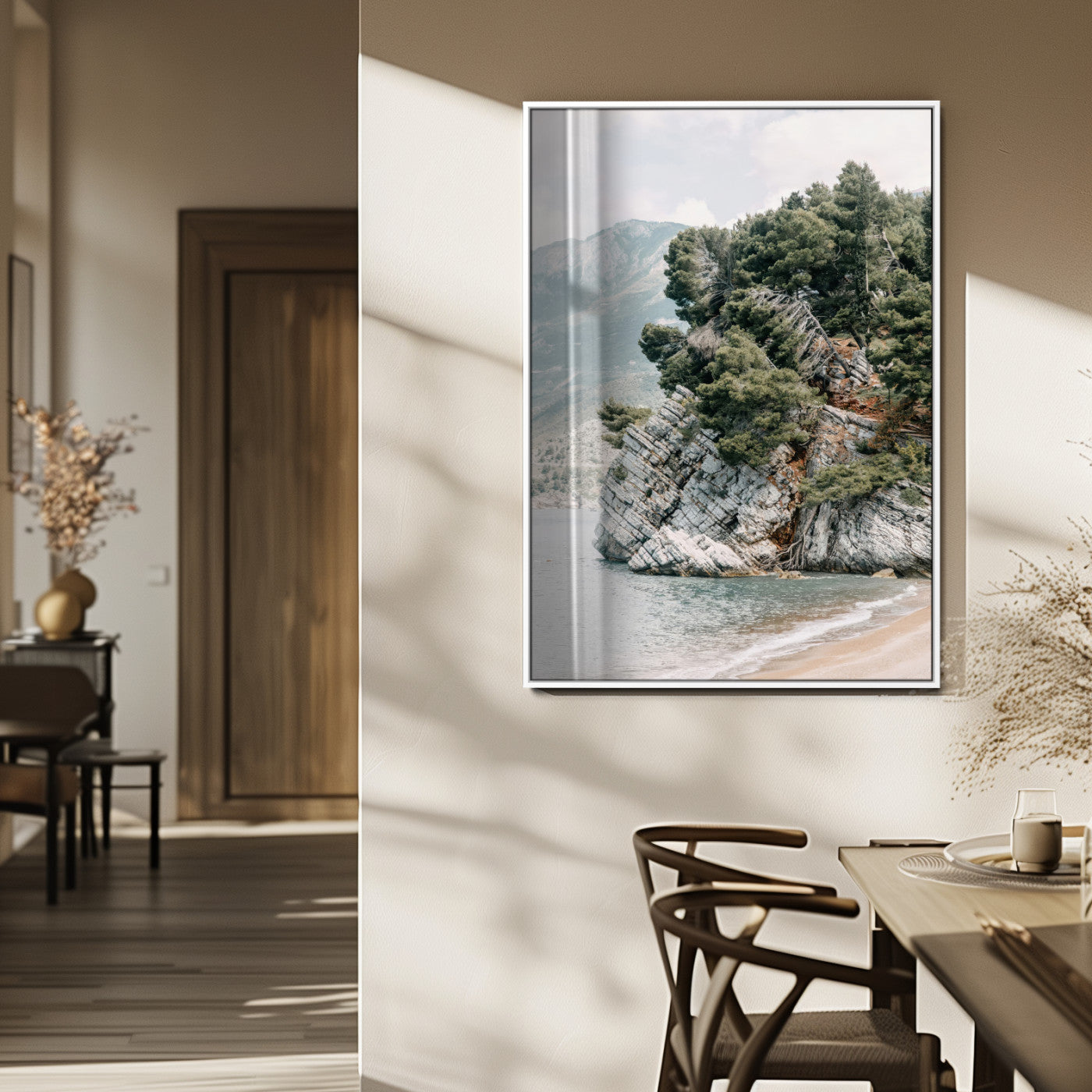 Framed photo of a rocky coastal cliff with dense greenery and calm shoreline, ideal for rustic coastal or earthy-toned home decor.