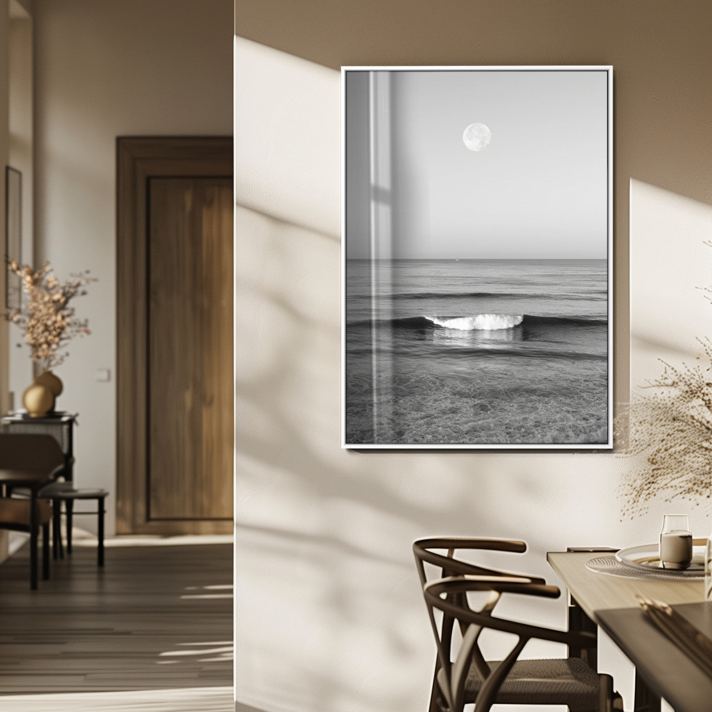 Black and white wall art of a calm ocean wave beneath a full moon, ideal for minimalist or monochrome coastal decor.