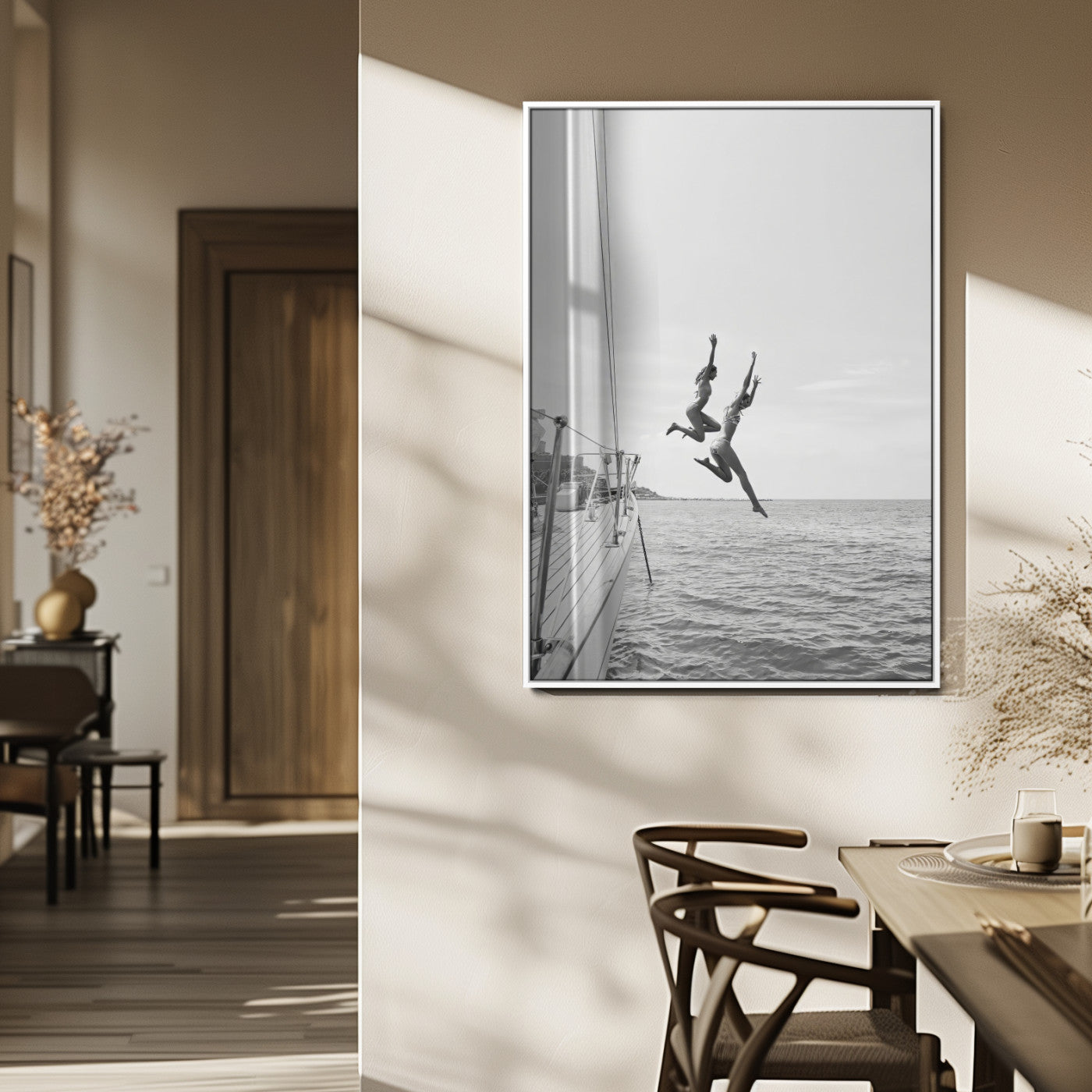 Black and white canvas wall art of two women joyfully jumping off a yacht into the sea, ideal for minimalist coastal or nautical-themed spaces.